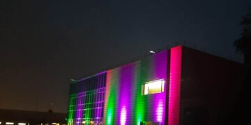 GALERIE. Imagini inedite cu o firmă din Oradea scăldată toată noapte în mov și verde.De ce au ales această imagine